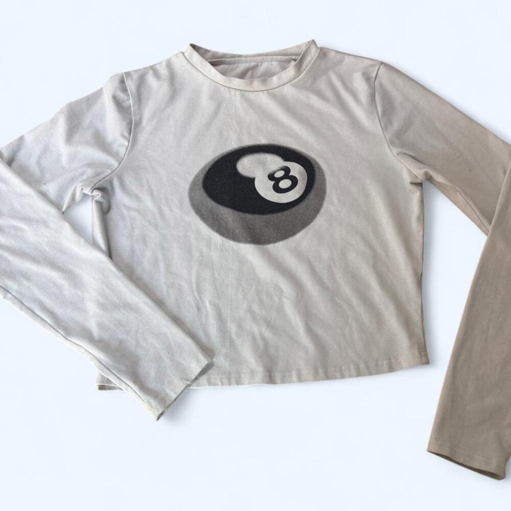 Cream long sleeve top with 8 ball graphic